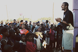 Myke Scholl speaking with a group of children and adults in South Africa